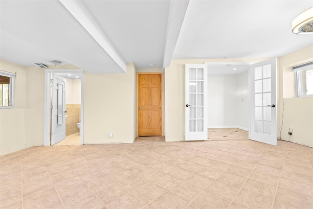 empty room featuring french doors and visible vents