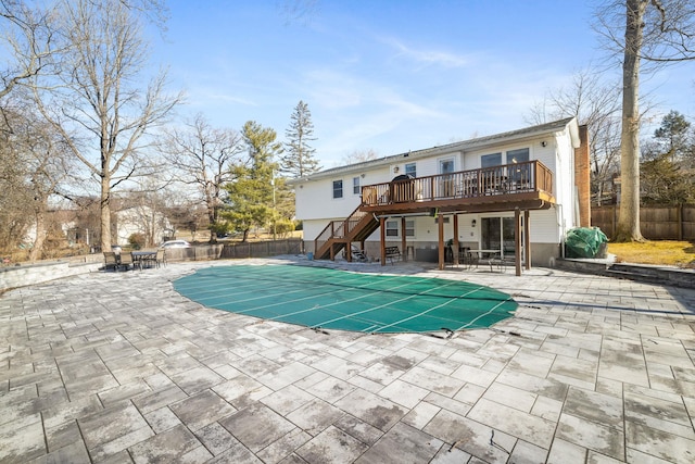 view of swimming pool featuring a fenced in pool, a patio, stairway, a fenced backyard, and a wooden deck