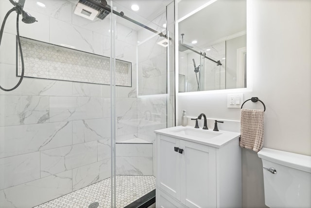 full bathroom featuring crown molding, toilet, vanity, and a marble finish shower