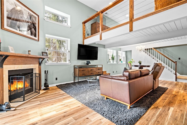 living room featuring hardwood / wood-style flooring, a wealth of natural light, and beam ceiling