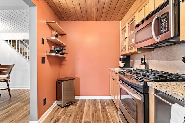 kitchen with appliances with stainless steel finishes, light stone countertops, decorative backsplash, light hardwood / wood-style floors, and wood ceiling