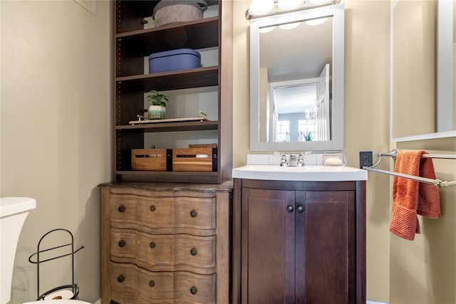 bathroom with toilet and vanity