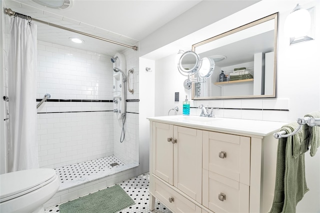 bathroom featuring toilet, vanity, and a shower with curtain