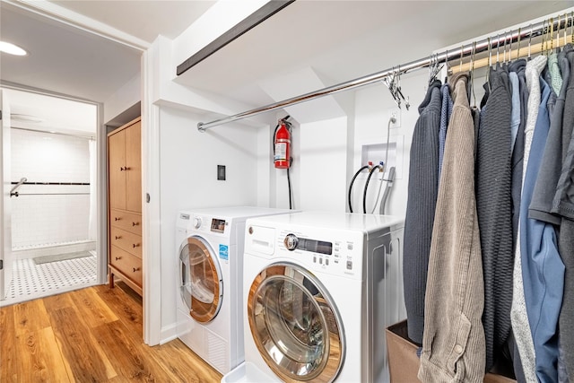 washroom featuring light hardwood / wood-style flooring and washer and clothes dryer