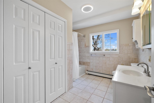 full bath featuring tile walls, a closet, tile patterned floors, and a baseboard radiator