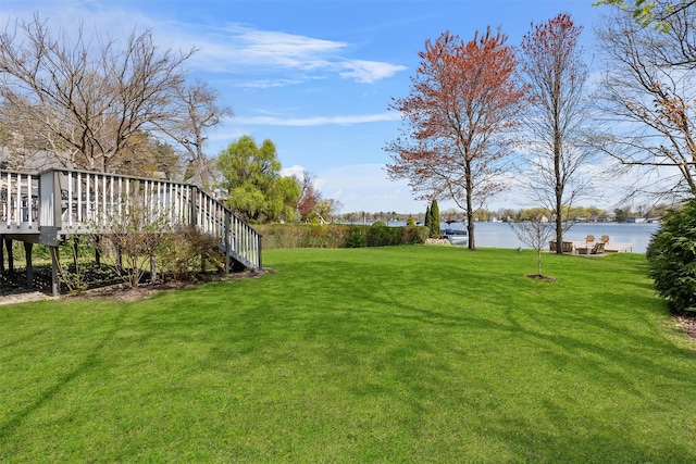 view of yard featuring a deck with water view
