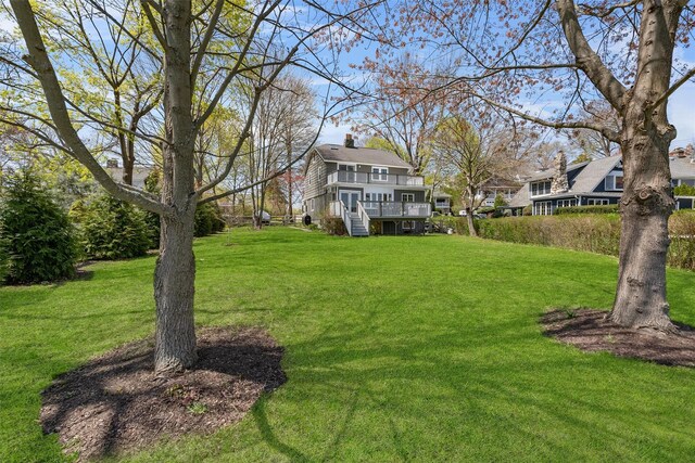 view of yard featuring stairway and a wooden deck