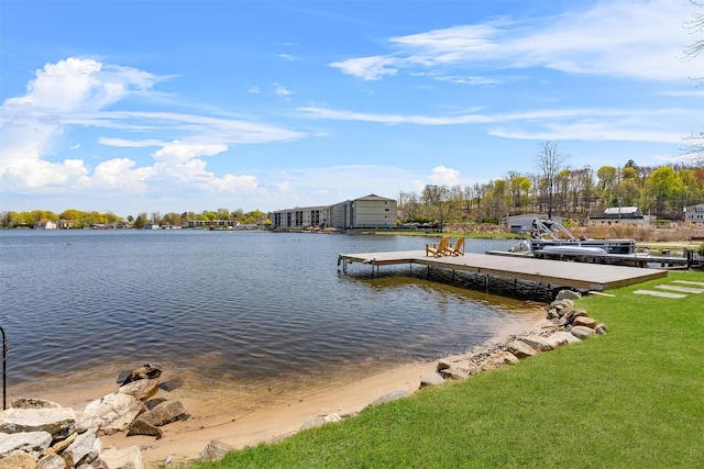 dock area with a lawn and a water view