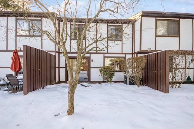 view of snow covered rear of property