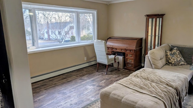 sitting room featuring a baseboard heating unit and wood finished floors