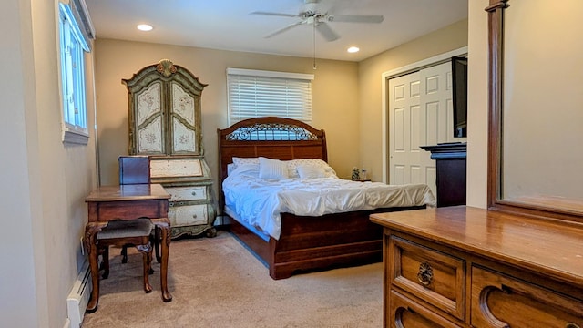 bedroom featuring recessed lighting, a baseboard radiator, light carpet, and multiple windows