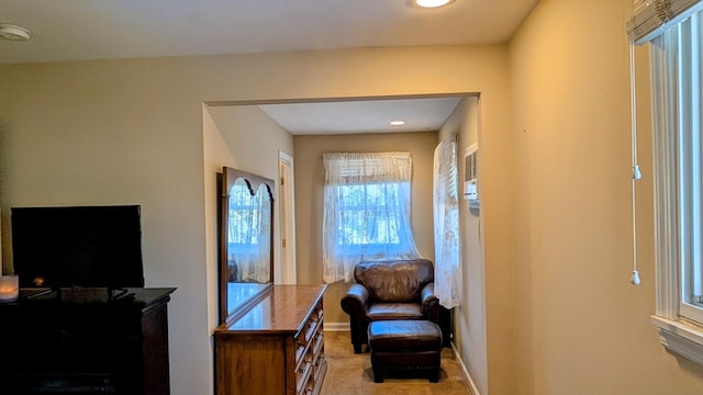 sitting room with baseboards and carpet floors