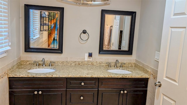 bathroom featuring a sink and double vanity