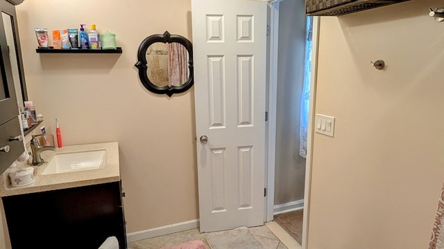 bathroom featuring baseboards, vanity, and tile patterned flooring