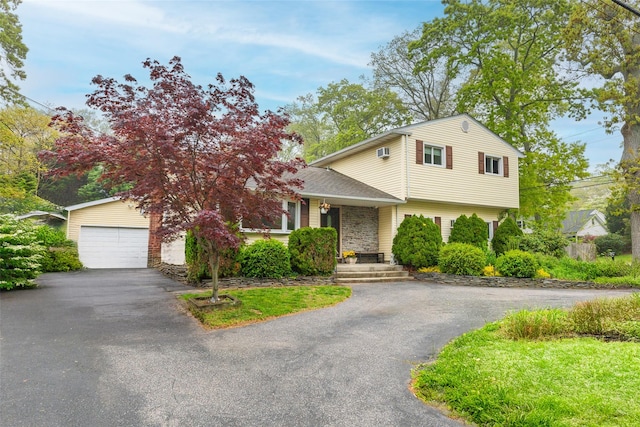 view of front of house with a garage and asphalt driveway
