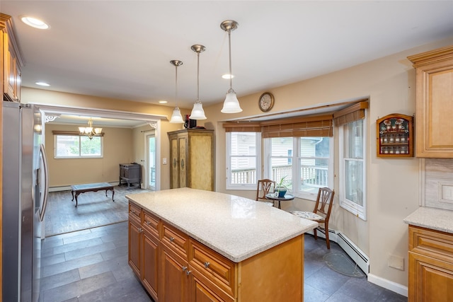 kitchen featuring stainless steel fridge with ice dispenser, baseboard heating, recessed lighting, a kitchen island, and pendant lighting