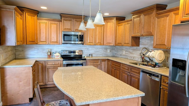 kitchen featuring stainless steel appliances, a kitchen island, recessed lighting, decorative backsplash, and light stone countertops