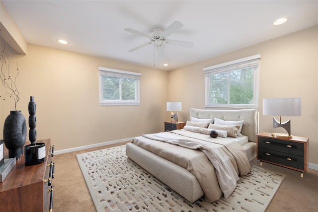 bedroom with light carpet, multiple windows, recessed lighting, baseboards, and ceiling fan