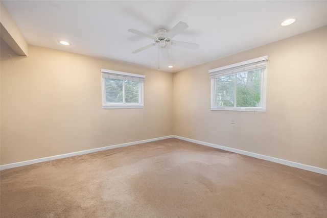 unfurnished room with healthy amount of natural light, recessed lighting, carpet flooring, and baseboards