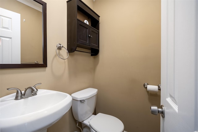 half bathroom with a sink and toilet