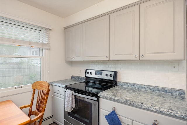 kitchen with stainless steel range with electric cooktop, decorative backsplash, and white cabinetry