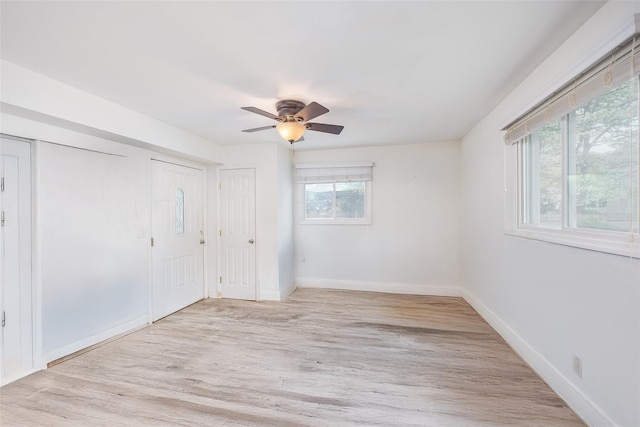 unfurnished bedroom featuring baseboards, light wood-style floors, and ceiling fan