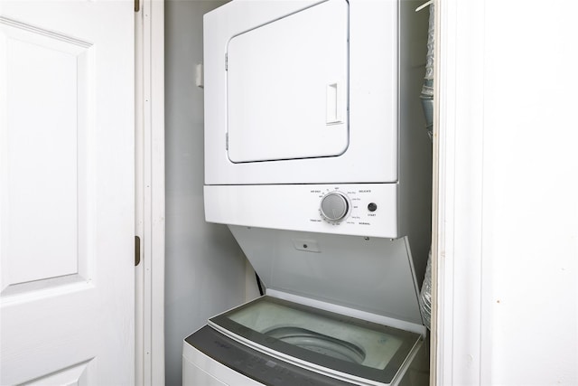 washroom with stacked washing machine and dryer