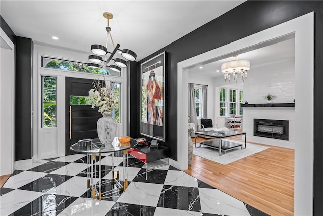 dining space with an inviting chandelier, a fireplace, baseboards, and recessed lighting