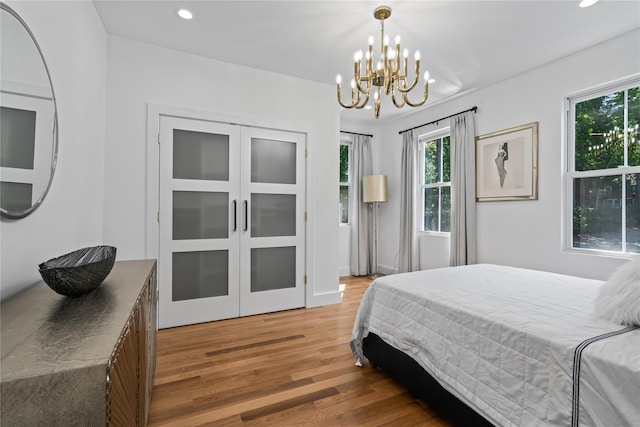 bedroom with light wood finished floors and recessed lighting