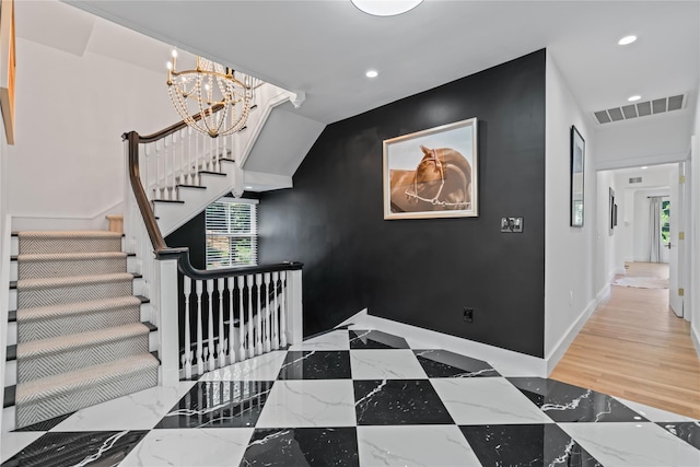 staircase featuring recessed lighting, an accent wall, visible vents, baseboards, and marble finish floor