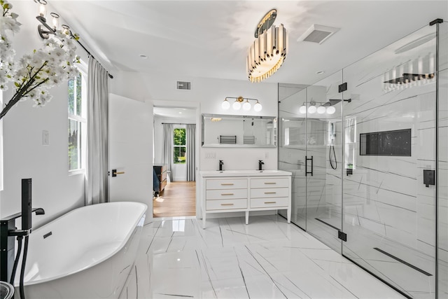 bathroom with marble finish floor, a soaking tub, visible vents, a stall shower, and vanity