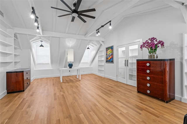 bonus room with built in shelves, light wood-type flooring, vaulted ceiling with beams, and baseboards