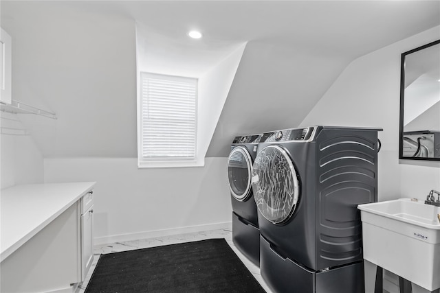 laundry room with marble finish floor, cabinet space, a sink, separate washer and dryer, and baseboards