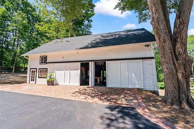 view of front of home featuring roof with shingles