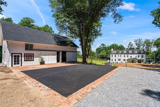 exterior space with roof with shingles