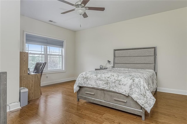 bedroom with ceiling fan and hardwood / wood-style floors