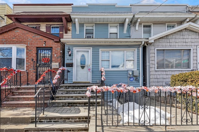 townhome / multi-family property with a fenced front yard