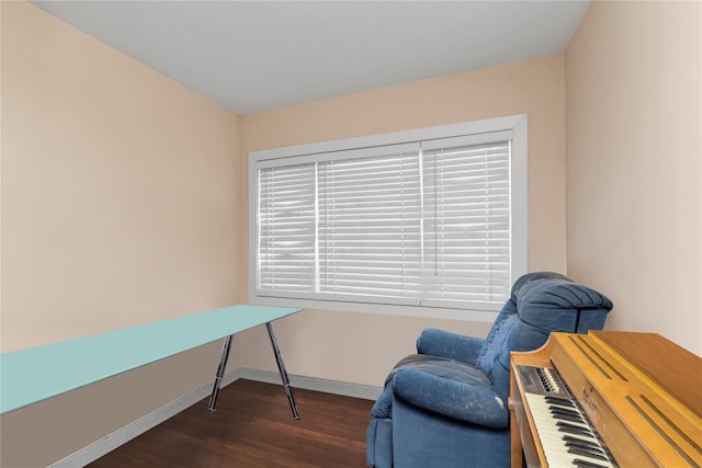 living area with wood finished floors and baseboards