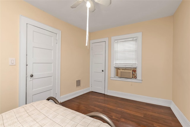 bedroom with dark wood-type flooring, cooling unit, visible vents, and baseboards