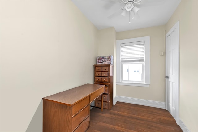 office featuring ceiling fan, baseboards, and dark wood-type flooring