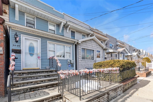 view of property with fence and a residential view