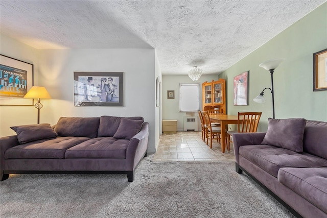 carpeted living area with a textured ceiling, radiator heating unit, and tile patterned flooring