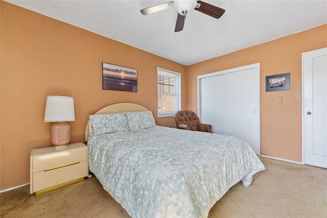 bedroom featuring a ceiling fan, carpet, a closet, and baseboards