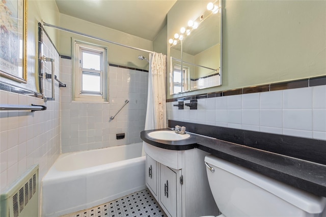 full bathroom featuring toilet, vanity, tile walls, radiator, and shower / tub combo with curtain