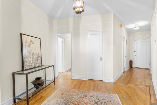 foyer entrance with baseboards and wood finished floors