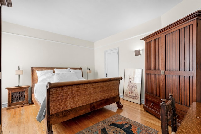 bedroom with light wood-style flooring and baseboards