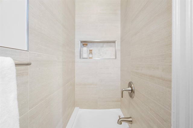 bathroom with tiled shower