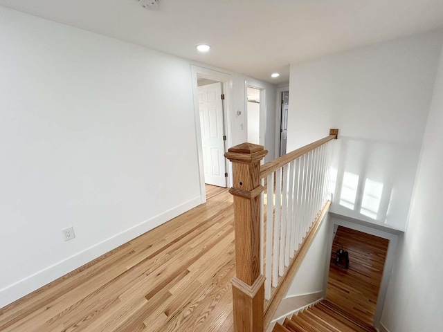 staircase with hardwood / wood-style floors