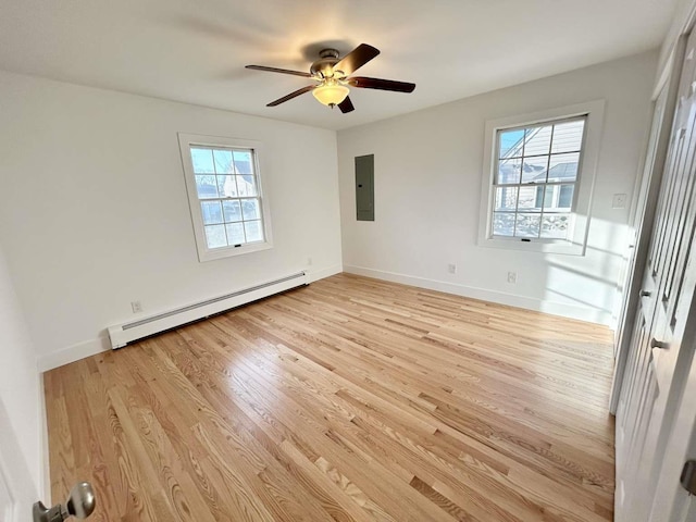 unfurnished bedroom featuring a baseboard heating unit, electric panel, ceiling fan, and light hardwood / wood-style flooring