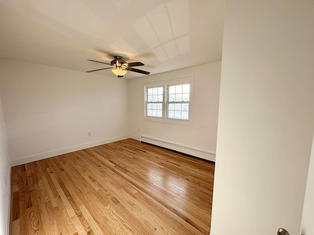 empty room featuring a baseboard radiator, ceiling fan, and light hardwood / wood-style flooring